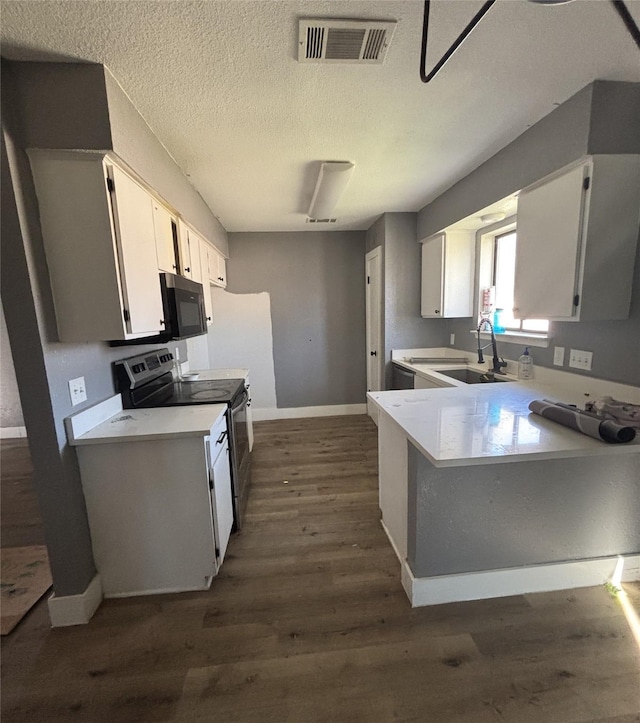 kitchen with sink, white cabinetry, range with electric cooktop, and dark wood-type flooring