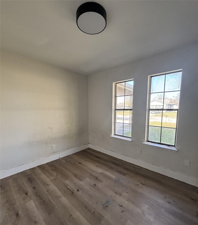 spare room with dark hardwood / wood-style flooring