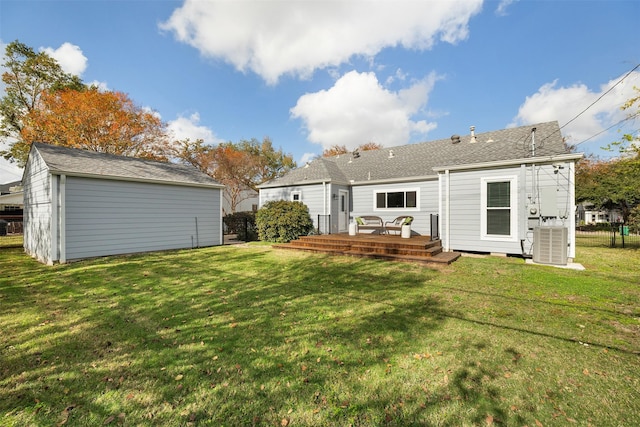 back of property with cooling unit, a deck, and a yard