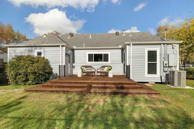 rear view of property with a lawn, a wooden deck, and central air condition unit