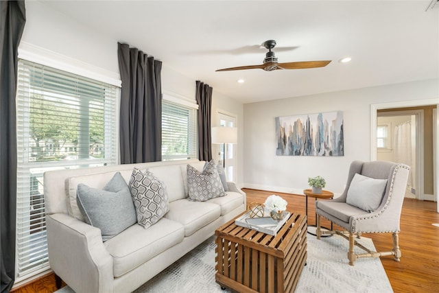 living room featuring ceiling fan and wood-type flooring