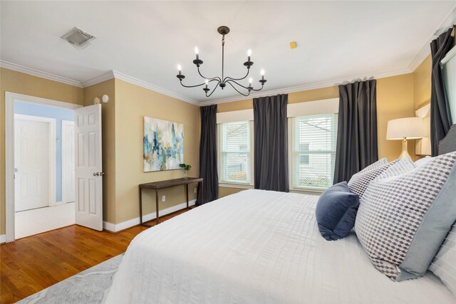 bedroom with wood-type flooring, crown molding, and a chandelier