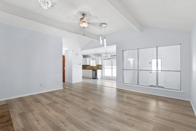 unfurnished living room with lofted ceiling with beams, light hardwood / wood-style floors, and ceiling fan with notable chandelier