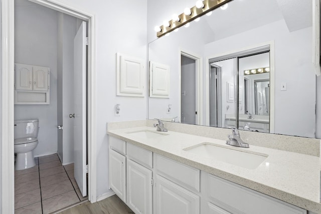 bathroom with tile patterned floors, vanity, and toilet