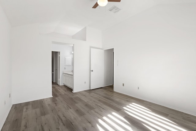 unfurnished bedroom with high vaulted ceiling, ceiling fan, connected bathroom, and light hardwood / wood-style flooring