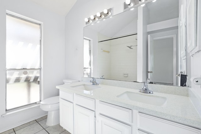 bathroom with vanity, a shower, tile patterned floors, vaulted ceiling, and toilet