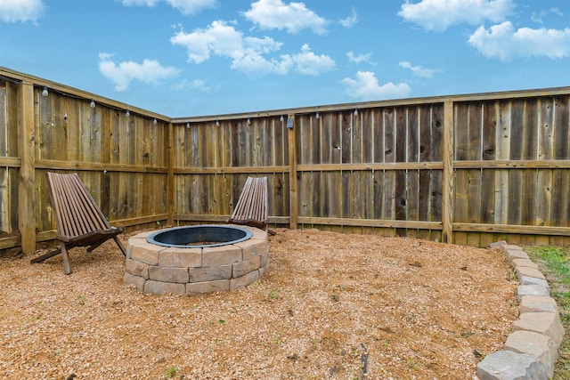 view of yard with a fire pit