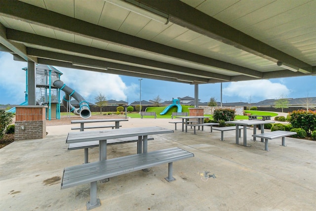 view of community featuring a playground and a patio