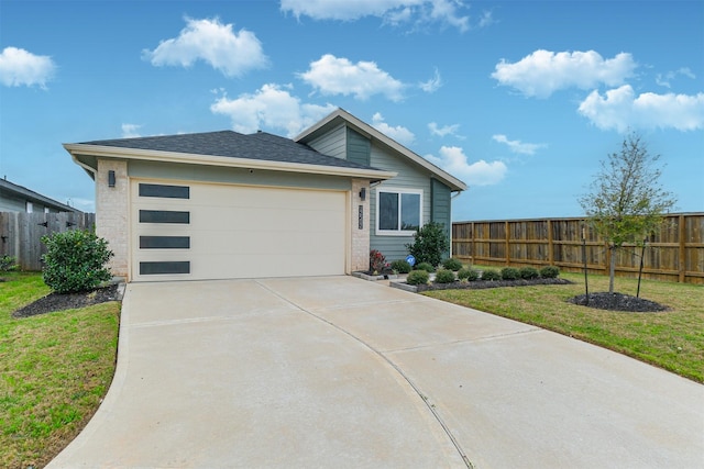 view of front of house with a garage and a front yard