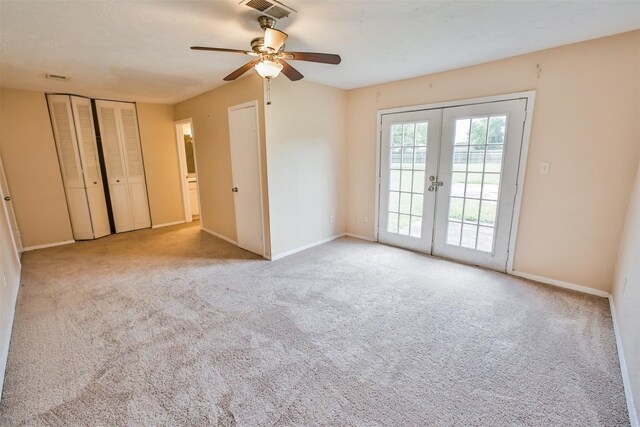 interior space featuring baseboards, visible vents, light colored carpet, and french doors