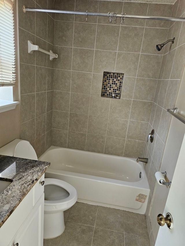 full bathroom featuring tile patterned floors, vanity, toilet, and tiled shower / bath