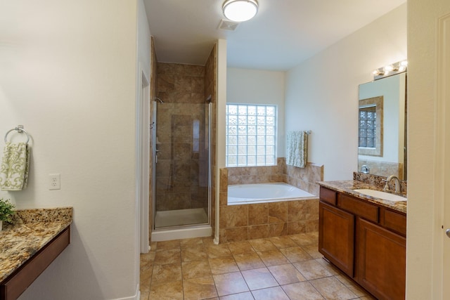 bathroom featuring tile patterned floors, vanity, and shower with separate bathtub