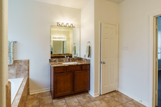 bathroom featuring tile patterned floors, tiled tub, and vanity