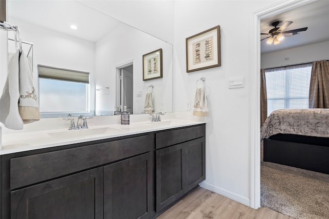 bathroom featuring ceiling fan, wood-type flooring, and vanity