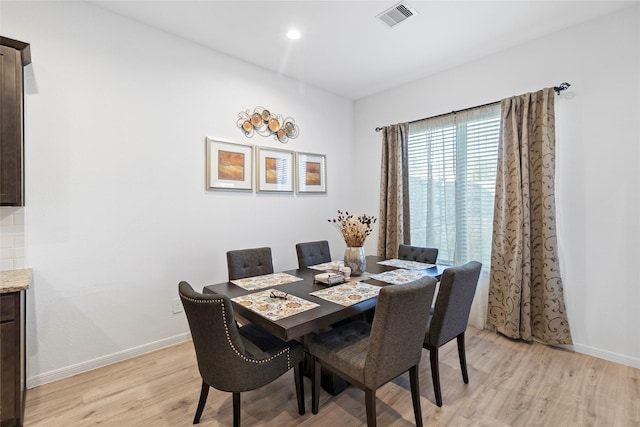 dining space with light wood-type flooring