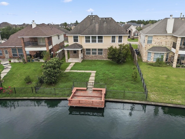 rear view of property featuring a yard and a water view