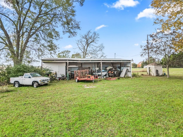 back of property with a yard and a shed