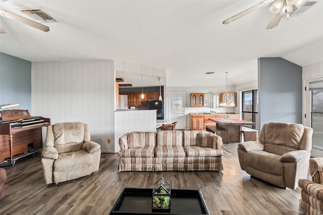 living room with ceiling fan, wood-type flooring, and vaulted ceiling