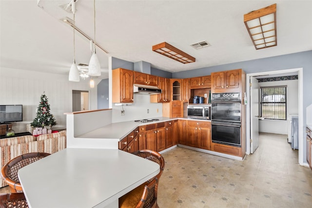 kitchen featuring white gas cooktop, rail lighting, ceiling fan, double oven, and decorative light fixtures