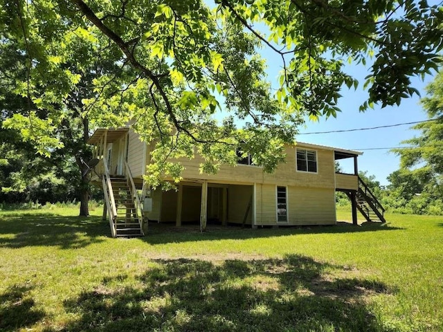 back of property featuring a yard