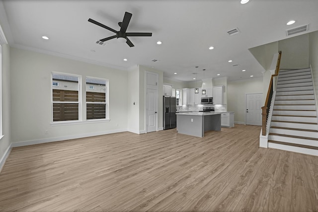 unfurnished living room featuring ceiling fan, crown molding, and light hardwood / wood-style floors