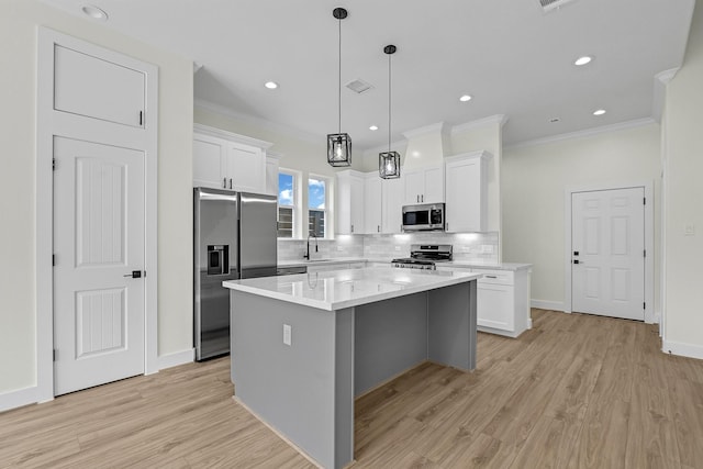 kitchen with a kitchen island, light wood-type flooring, white cabinetry, and stainless steel appliances