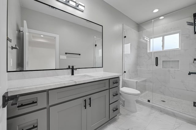 bathroom with vanity, toilet, and an enclosed shower