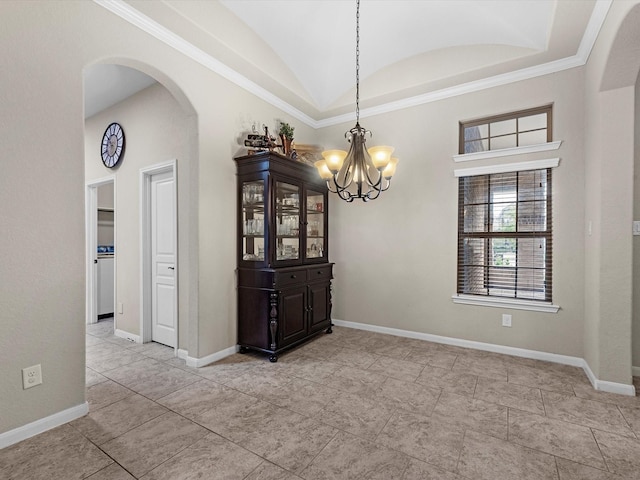 unfurnished dining area with a notable chandelier, ornamental molding, and lofted ceiling