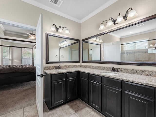 bathroom with a wealth of natural light, tile patterned floors, vanity, and crown molding