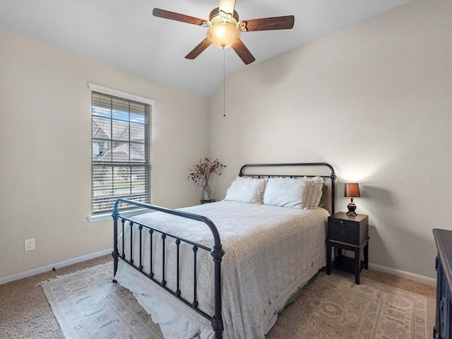 carpeted bedroom with ceiling fan and lofted ceiling