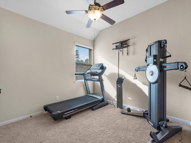 workout room with ceiling fan, carpet flooring, and lofted ceiling