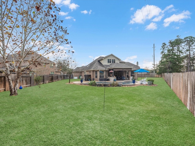 back of property with a yard and a patio