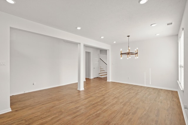 interior space with light hardwood / wood-style floors and an inviting chandelier