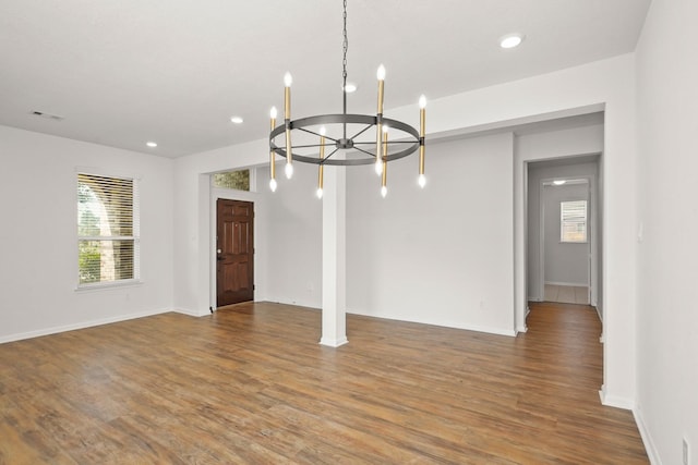 interior space featuring hardwood / wood-style flooring and an inviting chandelier