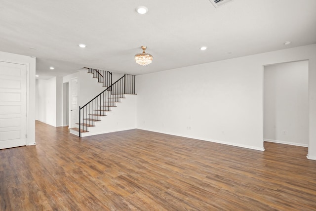 unfurnished living room featuring dark wood-type flooring