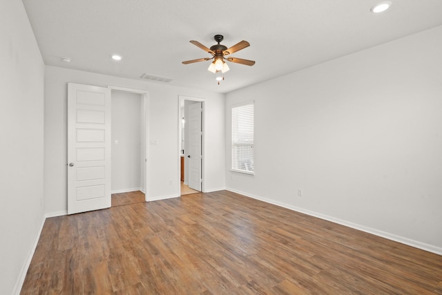 unfurnished bedroom with dark hardwood / wood-style flooring and ceiling fan