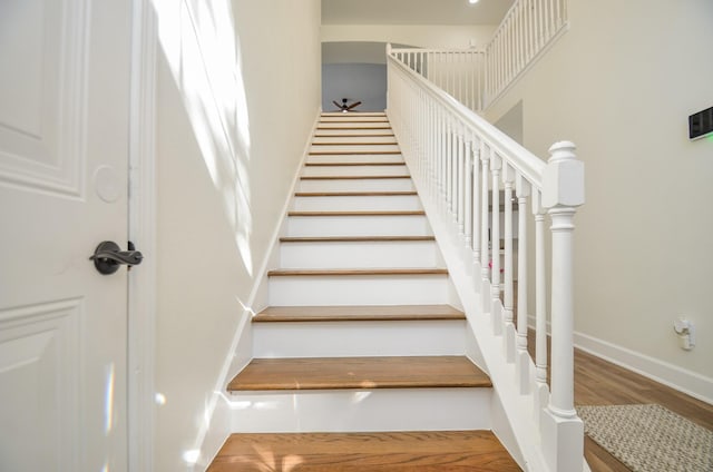 stairs featuring hardwood / wood-style flooring