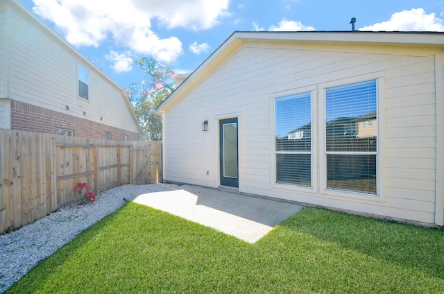 back of property featuring a patio and a lawn