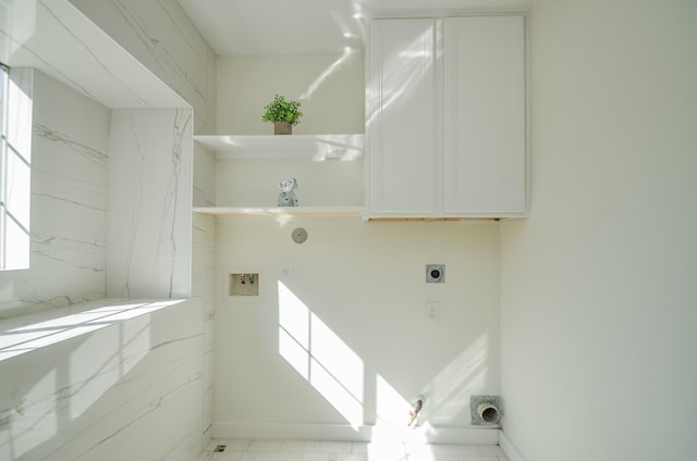 laundry area featuring hookup for an electric dryer, washer hookup, hookup for a gas dryer, and cabinets