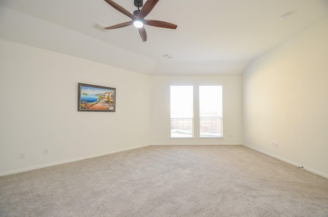 carpeted empty room featuring ceiling fan and lofted ceiling