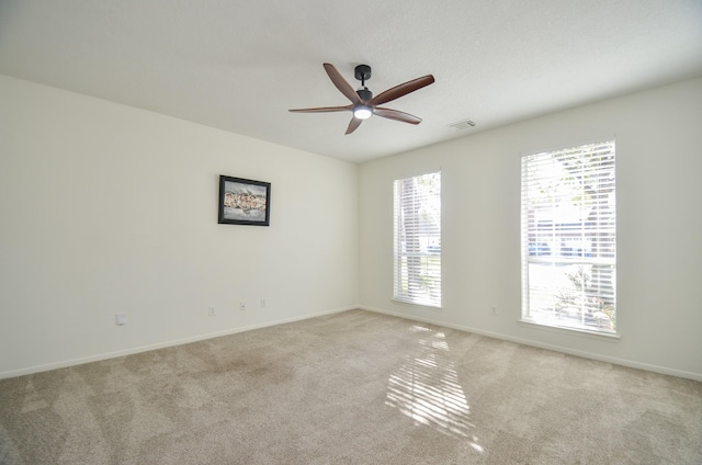 carpeted empty room featuring ceiling fan