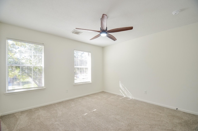 unfurnished room featuring a healthy amount of sunlight and light colored carpet