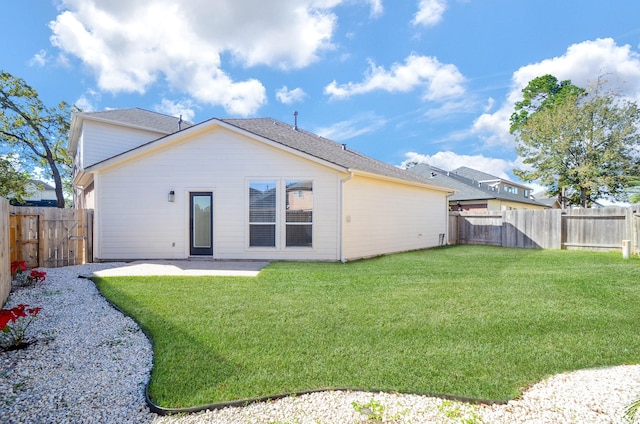 rear view of house with a lawn and a patio area