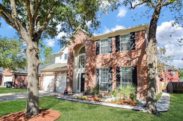 colonial home featuring a garage and a front yard