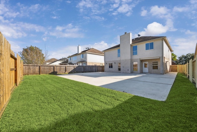 back of property featuring a yard and a patio