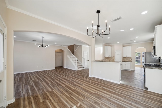 kitchen with crown molding, decorative backsplash, a notable chandelier, dark hardwood / wood-style flooring, and white cabinetry