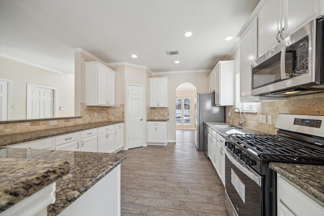 kitchen with white cabinets, dark stone countertops, sink, and appliances with stainless steel finishes