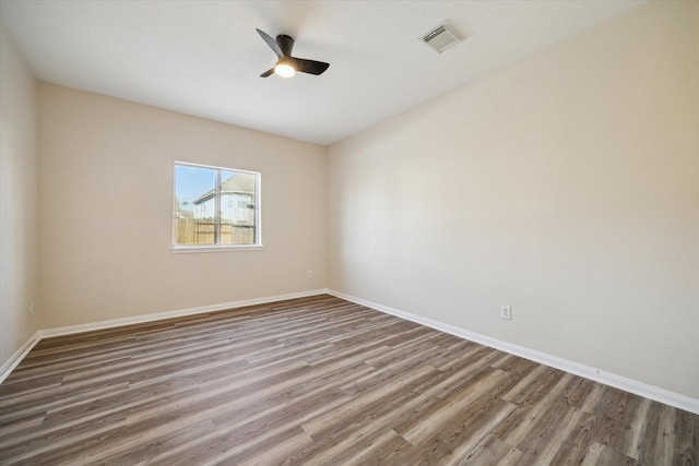 empty room featuring ceiling fan and hardwood / wood-style flooring