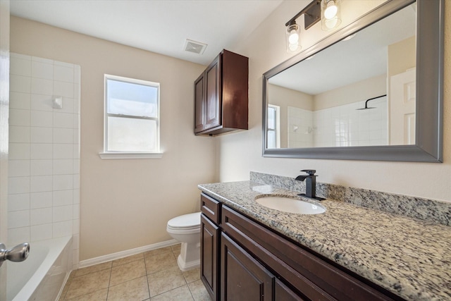 full bathroom featuring toilet, vanity, tile patterned floors, and tiled shower / bath