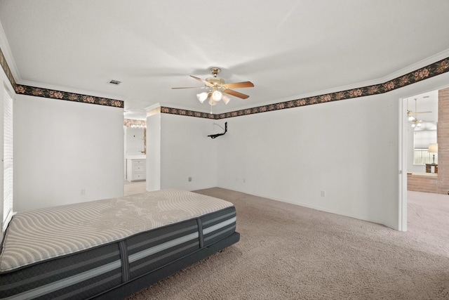 bedroom with visible vents, crown molding, and carpet flooring